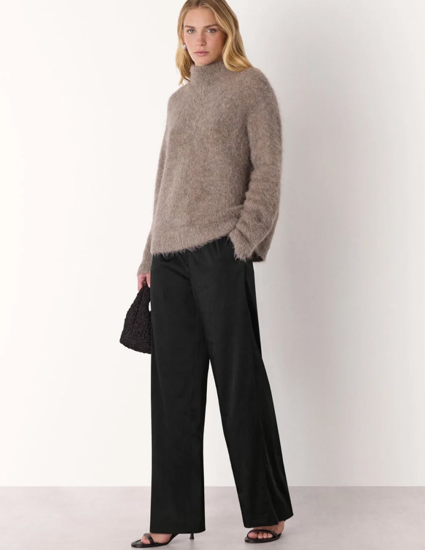 woman wearing shearling leather jacket with jeans